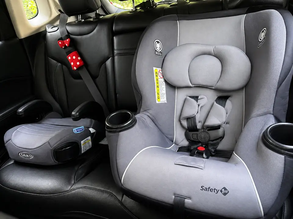 Car seat and booster installed in Jeep